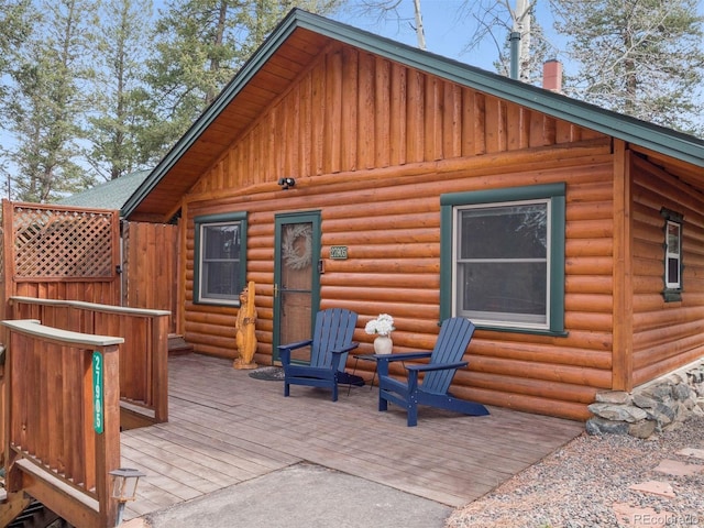 27905 Mariposa Rd, Evergreen, CO 80439 - back of house featuring board and batten siding, a wooden deck, and faux log siding