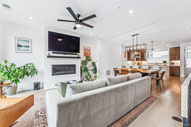 living room with hardwood / wood-style flooring and ceiling fan