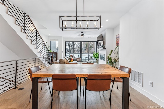 dining room featuring light hardwood / wood-style floors and ceiling fan