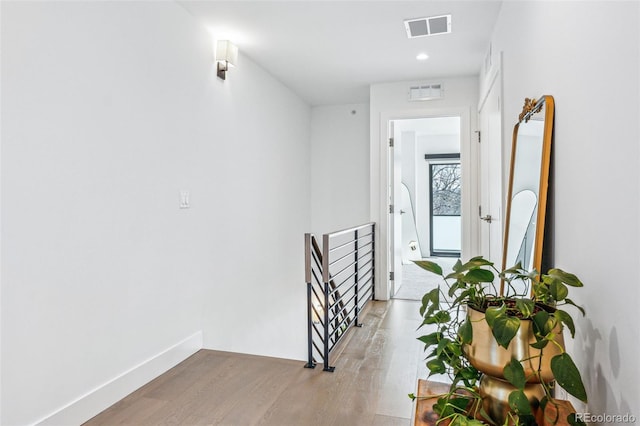 corridor with light hardwood / wood-style floors