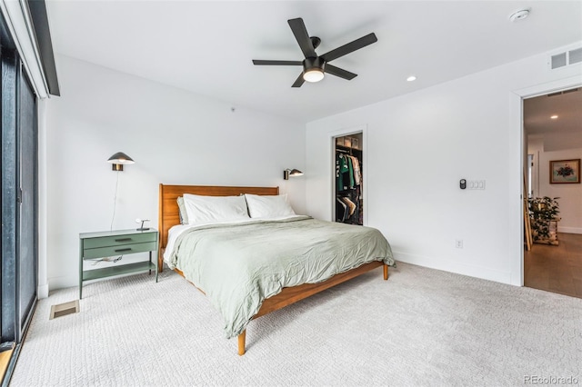 bedroom with ceiling fan, carpet flooring, a closet, and a walk in closet