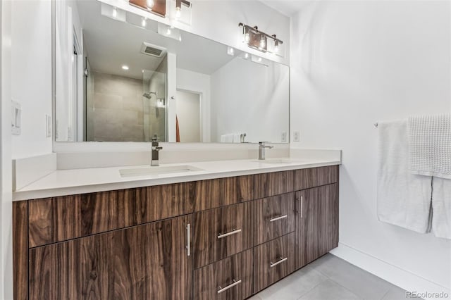 bathroom featuring vanity, tile patterned floors, and walk in shower