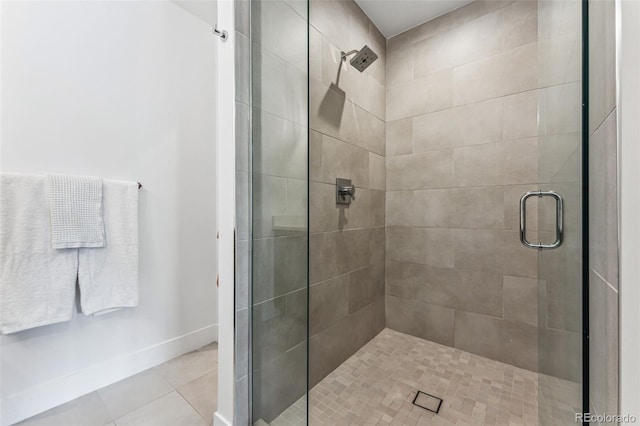 bathroom featuring tile patterned flooring and an enclosed shower