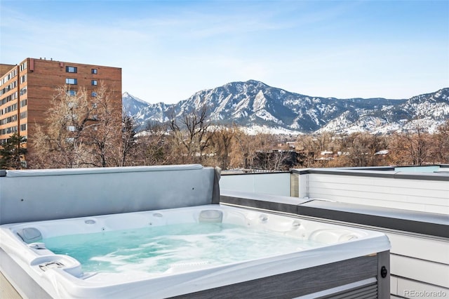 exterior space with a mountain view and a hot tub