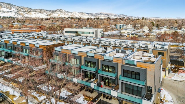 snowy aerial view featuring a mountain view