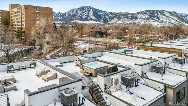 snowy aerial view with a mountain view