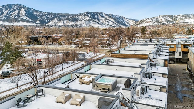 snowy aerial view with a mountain view