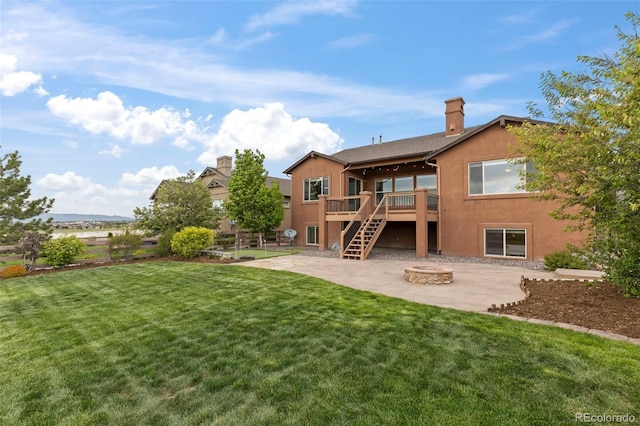 2423 Delicato Ct, Colorado Springs, CO 80921 - back of house with an outdoor fire pit, a patio, a wooden deck, stairway, and a chimney