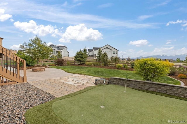 2423 Delicato Ct, Colorado Springs, CO 80921 - view of yard with a fire pit, a patio area, an area to practice putting, and a mountain view