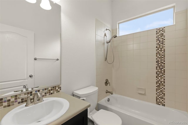 2423 Delicato Ct, Colorado Springs, CO 80921 - full bathroom with toilet, decorative backsplash, vanity, and tub / shower combination