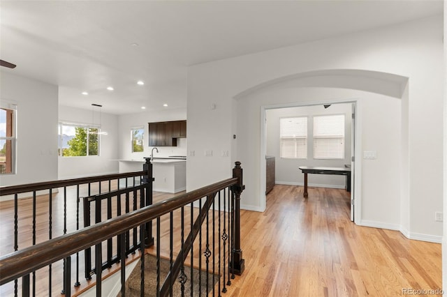 2423 Delicato Ct, Colorado Springs, CO 80921 - hallway featuring an upstairs landing, light wood-style floors, recessed lighting, a sink, and baseboards