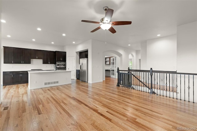 2423 Delicato Ct, Colorado Springs, CO 80921 - kitchen featuring stainless steel fridge with ice dispenser, arched walkways, ceiling fan, open floor plan, and recessed lighting