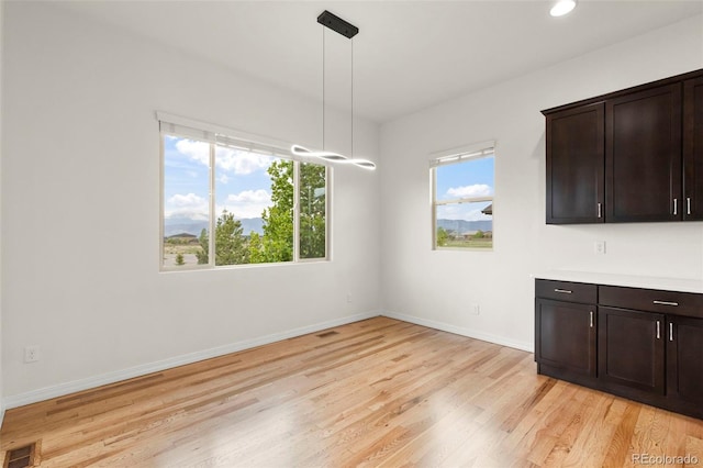 2423 Delicato Ct, Colorado Springs, CO 80921 - unfurnished dining area featuring light wood-type flooring, baseboards, and recessed lighting