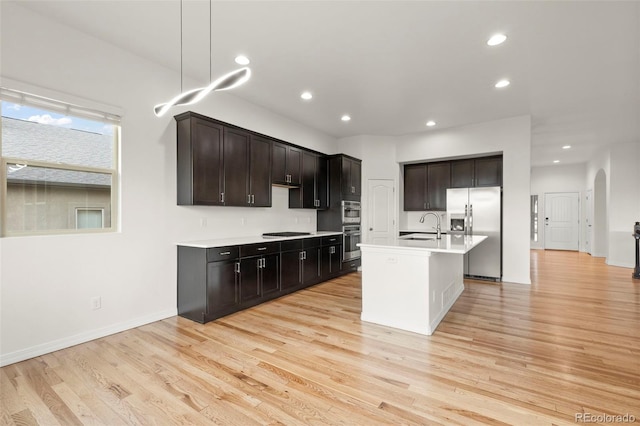 2423 Delicato Ct, Colorado Springs, CO 80921 - kitchen featuring appliances with stainless steel finishes, a sink, light wood-style floors, recessed lighting, and light countertops