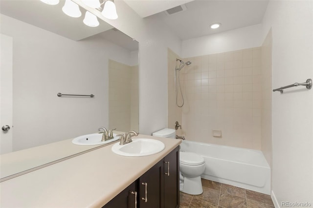 2423 Delicato Ct, Colorado Springs, CO 80921 - bathroom featuring toilet, vanity, tub / shower combination, and stone finish floors