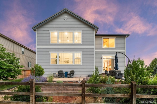 5984 S Paris Pl, Greenwood Village, CO 80111 - back of house at dusk with a patio area