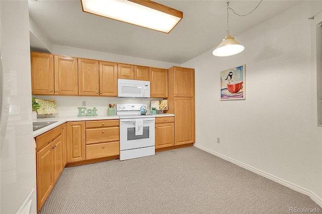 kitchen featuring light colored carpet, white appliances, and pendant lighting