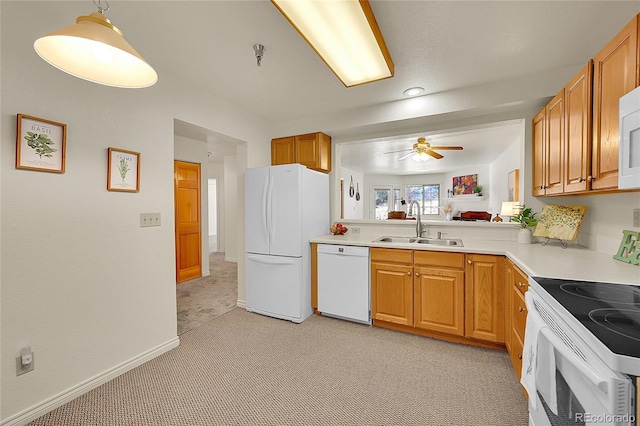 kitchen featuring ceiling fan, sink, white appliances, hanging light fixtures, and light carpet