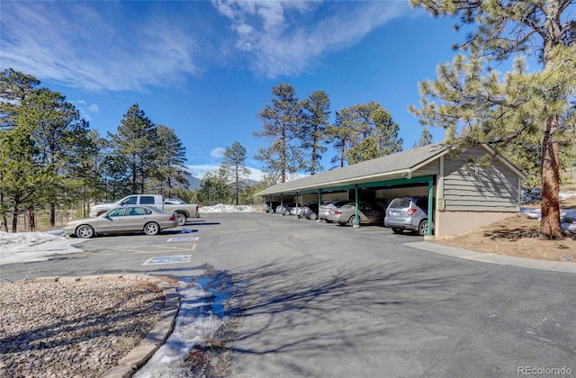 view of parking / parking lot featuring a carport