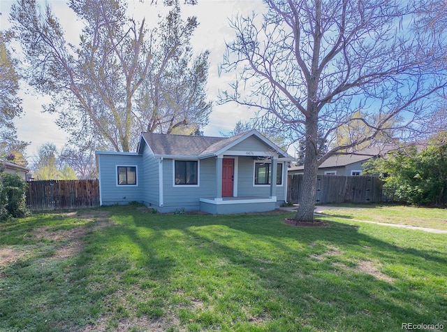 4476 S Grant St, Englewood, CO 80113 - view of front of house with a front lawn, fence, a porch, and a shingled roof