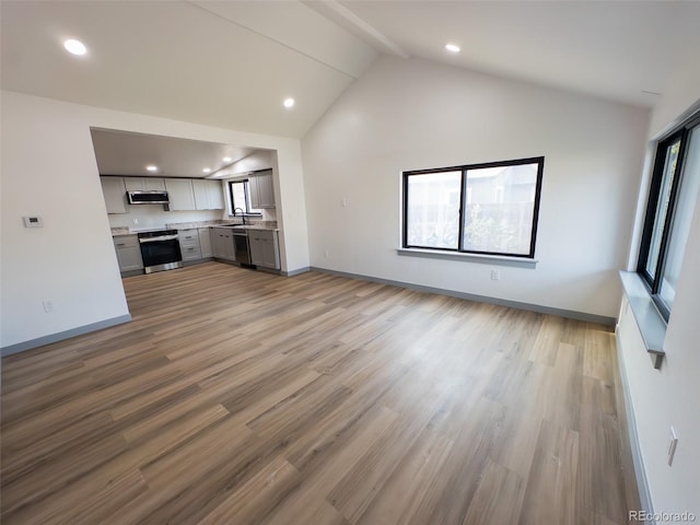 4476 S Grant St, Englewood, CO 80113 - unfurnished living room featuring baseboards, a sink, and recessed lighting