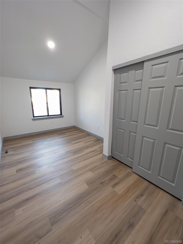 4476 S Grant St, Englewood, CO 80113 - additional living space with light wood-style floors, lofted ceiling, and baseboards