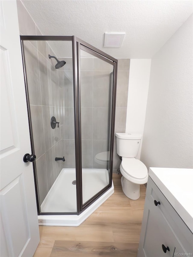 4476 S Grant St, Englewood, CO 80113 - full bath featuring toilet, wood finished floors, and a stall shower