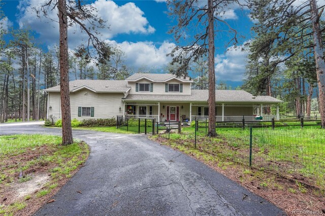 18470 Canterbury Dr, Monument, CO 80132 - view of front of home with a porch, driveway, and a gate