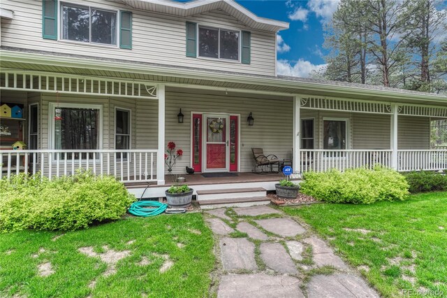 18470 Canterbury Dr, Monument, CO 80132 - view of front of property featuring covered porch and a front lawn