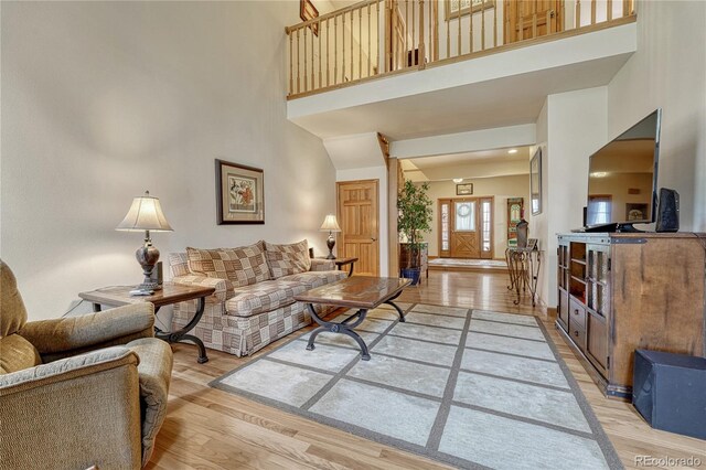 18470 Canterbury Dr, Monument, CO 80132 - living area featuring light wood-style flooring and a towering ceiling