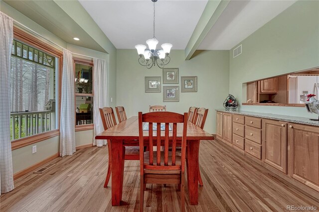 18470 Canterbury Dr, Monument, CO 80132 - dining space with a chandelier and light wood-style floors