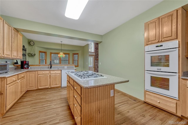 18470 Canterbury Dr, Monument, CO 80132 - kitchen featuring white appliances, light wood-type flooring, a peninsula, and light countertops