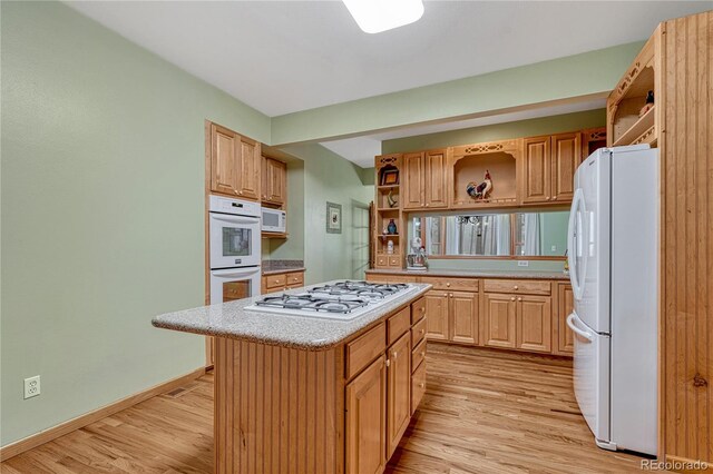 18470 Canterbury Dr, Monument, CO 80132 - kitchen featuring open shelves, white appliances, light wood finished floors, light countertops, and a kitchen island