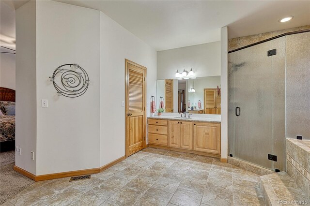 18470 Canterbury Dr, Monument, CO 80132 - full bath with connected bathroom, vanity, a stall shower, and stone finish flooring