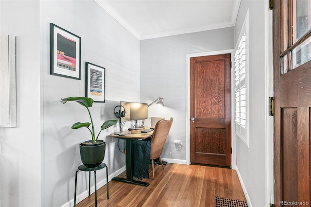 foyer entrance with crown molding and hardwood / wood-style floors