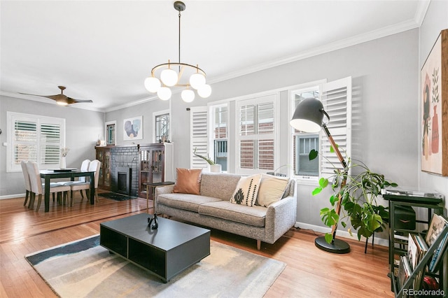 living room featuring wood-type flooring, a fireplace, and ornamental molding