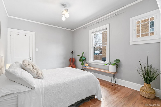 bedroom featuring crown molding and wood-type flooring