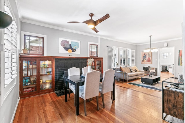 525 N Pearl St, Denver, CO 80203 - dining room featuring a fireplace, crown molding, plenty of natural light, and wood finished floors
