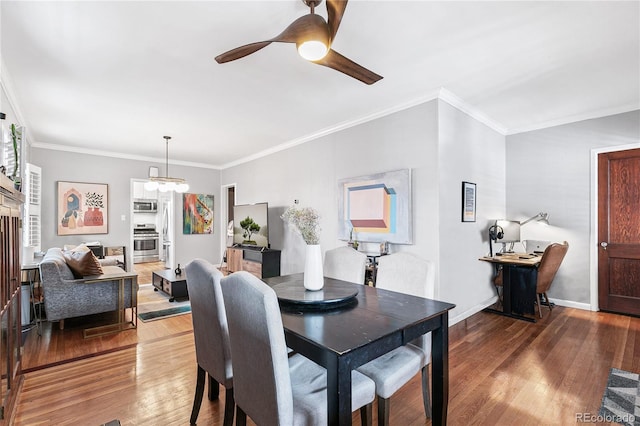 525 N Pearl St, Denver, CO 80203 - dining space with crown molding, ceiling fan with notable chandelier, baseboards, and wood finished floors