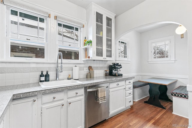 525 N Pearl St, Denver, CO 80203 - kitchen featuring a sink, stainless steel dishwasher, arched walkways, and a healthy amount of sunlight
