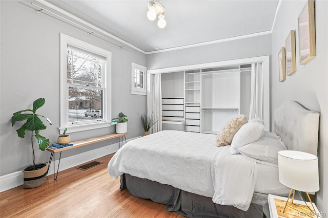525 N Pearl St, Denver, CO 80203 - bedroom featuring crown molding, visible vents, wood finished floors, and baseboards