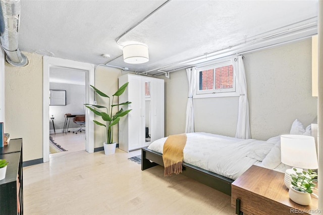 525 N Pearl St, Denver, CO 80203 - bedroom with a textured ceiling and wood finished floors