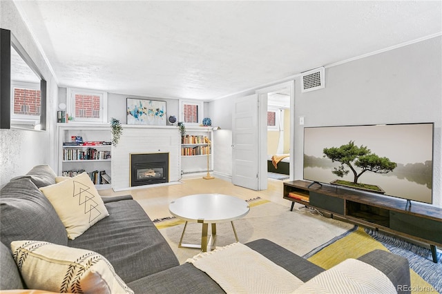 525 N Pearl St, Denver, CO 80203 - living room with a glass covered fireplace, visible vents, and wood finished floors