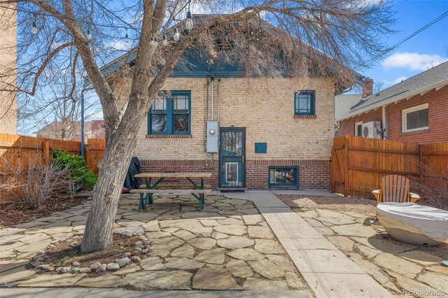 525 N Pearl St, Denver, CO 80203 - rear view of property with fence, a patio area, and brick siding