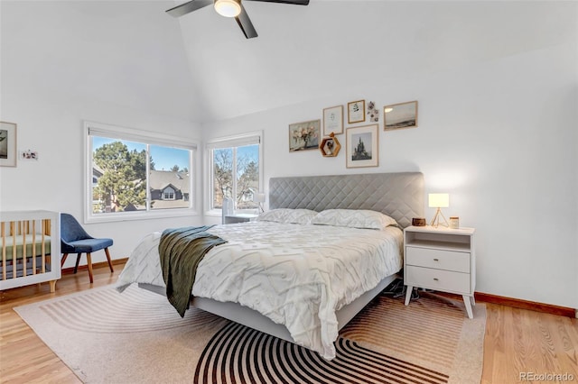 bedroom with baseboards, wood finished floors, and vaulted ceiling