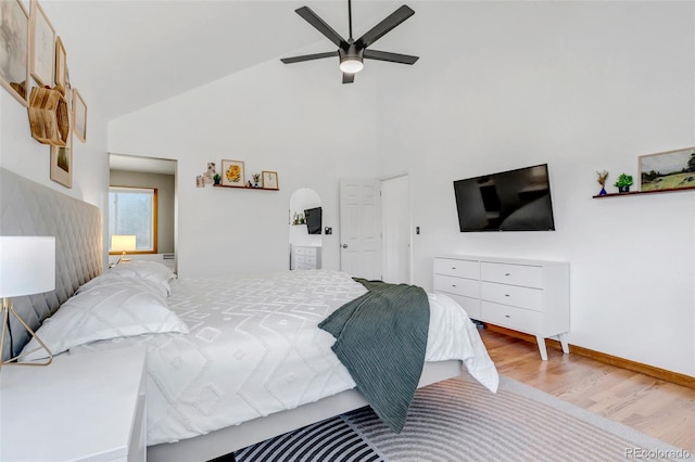 bedroom featuring high vaulted ceiling, a ceiling fan, baseboards, and wood finished floors