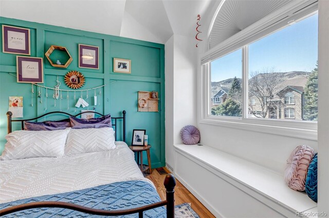 bedroom with baseboards and wood finished floors