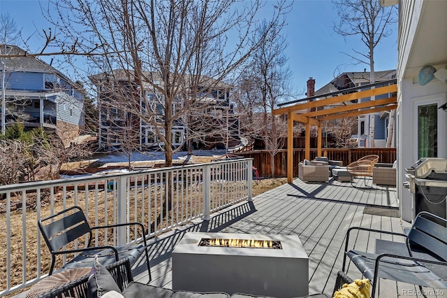 deck featuring a pergola, an outdoor living space with a fire pit, and fence