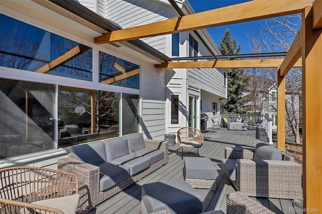 wooden terrace with area for grilling and an outdoor hangout area