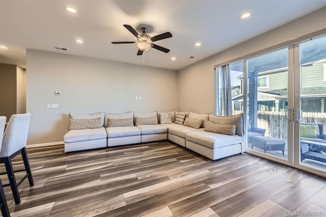 living room with a ceiling fan, visible vents, wood finished floors, and recessed lighting